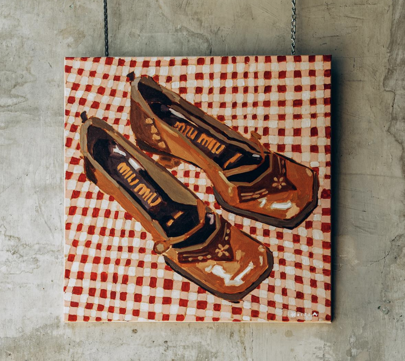 A painting showing a red pair of women's shoes on a red and white checked background.